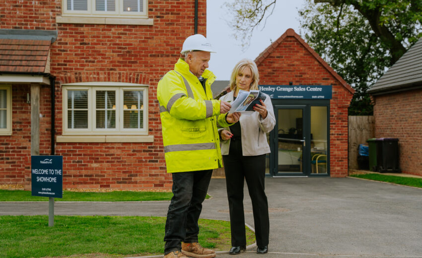 Two people viewing a new build house on site.