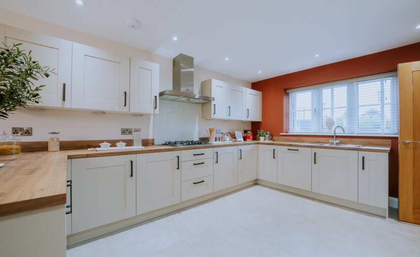 Henley Grange - Bright contemporary kitchen with white cabinets and island.