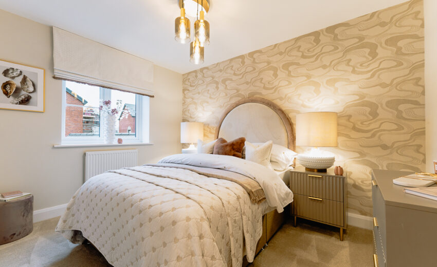 New build bedroom with feature wall and bedside lamp.