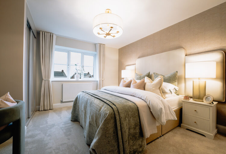 New build bedroom with neutral bedding and pendant light.