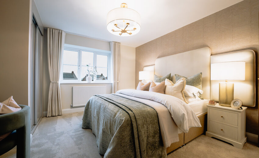 New build bedroom with neutral bedding and pendant light.