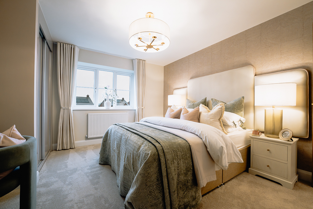 New build bedroom with neutral bedding and pendant light.