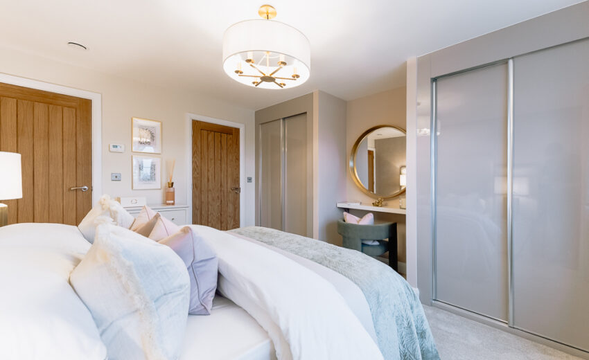 New build bedroom with neutral bedding and curtains.