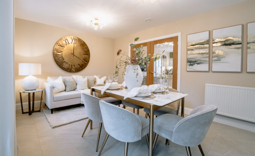 New build dining area with table and wall art.