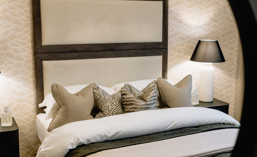 New build bedroom with neutral bedding and headboard.