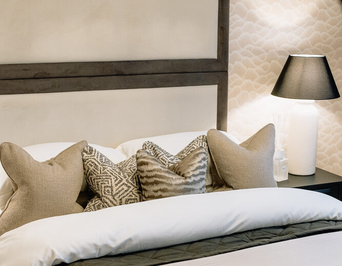 Bedroom with upholstered headboard in a new build.