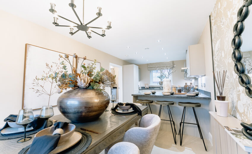 New build dining area with decorative vase and pendant light.