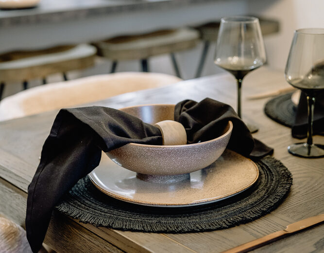 New build dining table setting with crockery and napkin.
