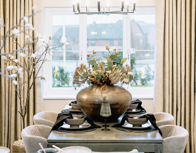Dining table set in a bright new build open-plan space.