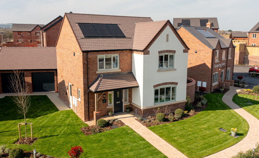 New build house exterior with driveway and pitched roof.