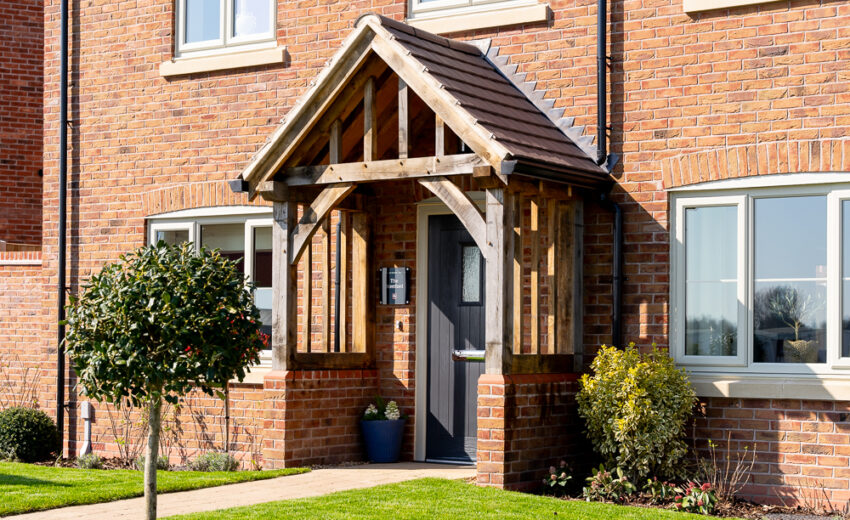 New build exterior house view with pitched roof.