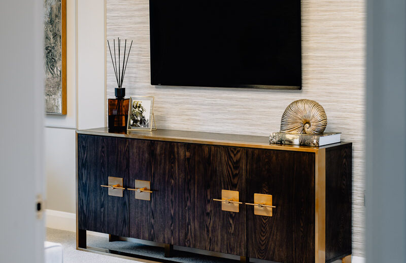 New build living room with media unit and mirror.