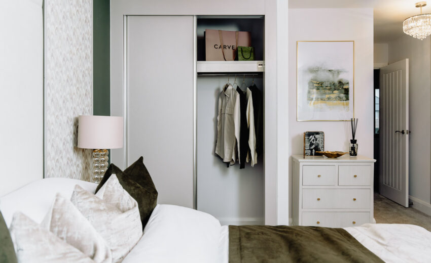 New build bedroom wardrobe with hanging space and shelving.