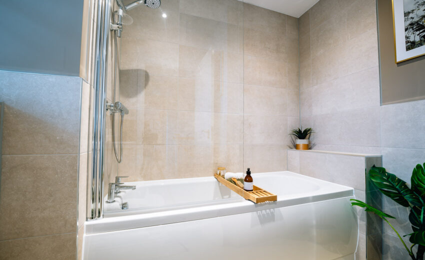 New build bathroom with shower and bath tray.